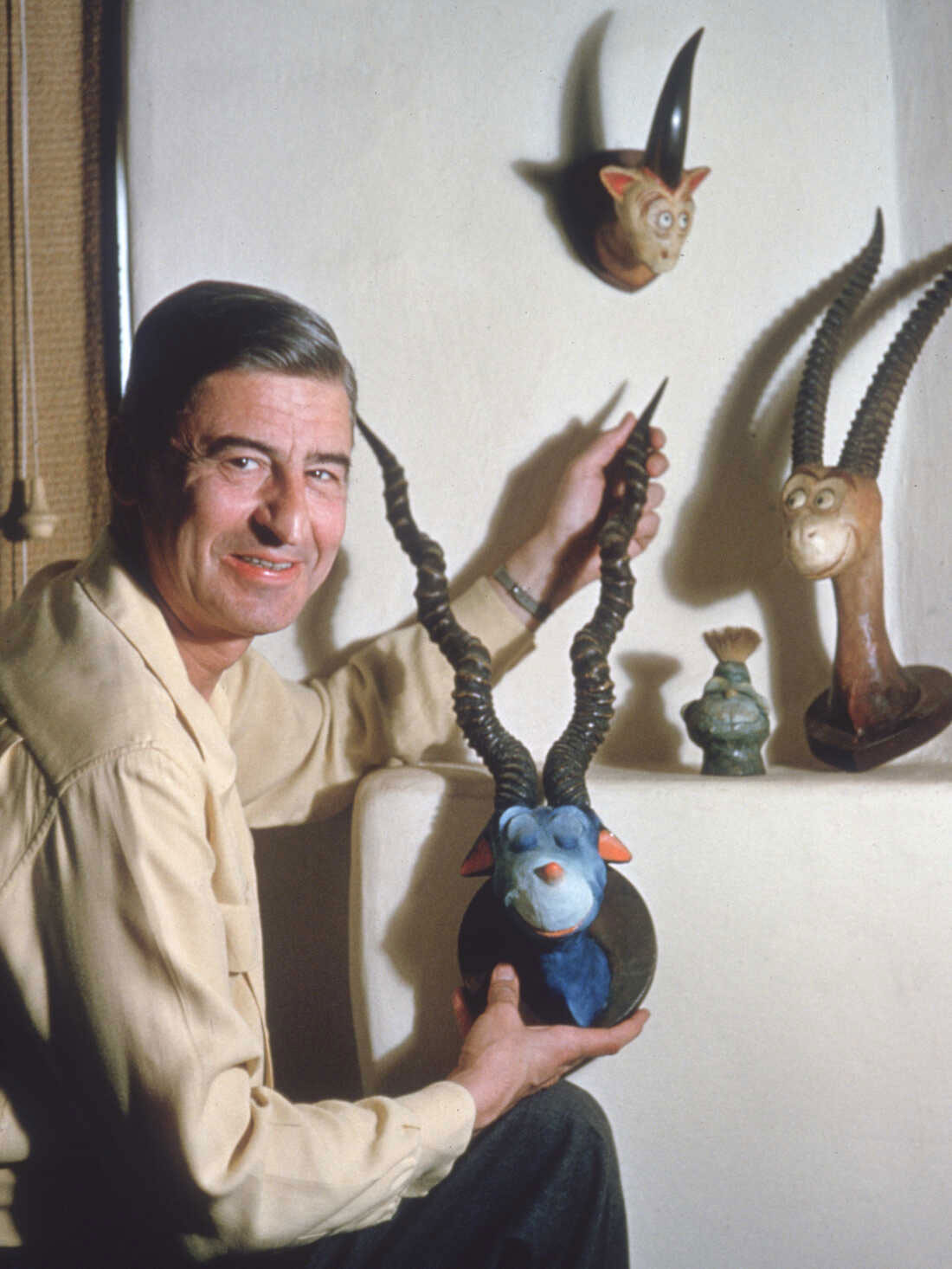 Geisel eventually created 17 whimsical creatures — eight of which are still in the collection of his estate, and a couple of which are owned by collectors. He is shown with Two Horned Drouberhannis, Blue-Green Abelard, Mulberry Street Unicorn, and the Mugglesmirt