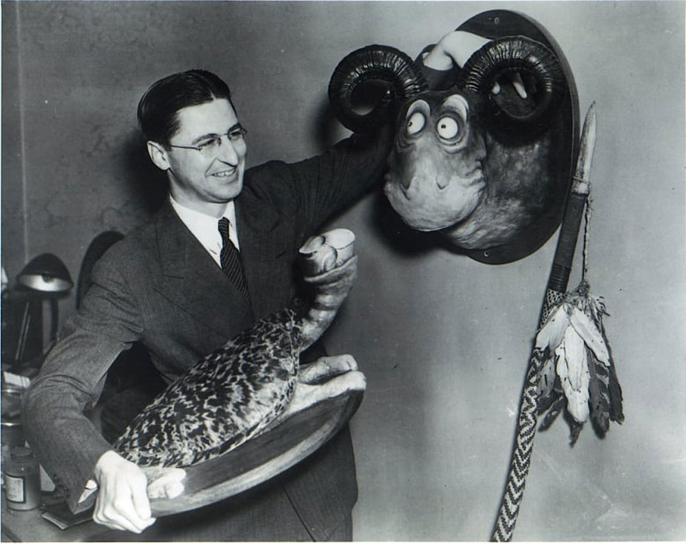 Ted "Dr. Seuss" Geisel holds the original Goo-Goo-Eyed Tasmanian Wolghast and Turtle-Necked Sea Turtle Unorthodox Taxidermy Sculptures.
